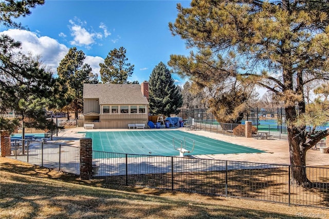 pool with fence and a patio