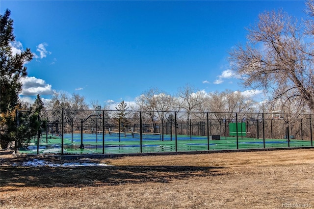 view of sport court with a tennis court and fence