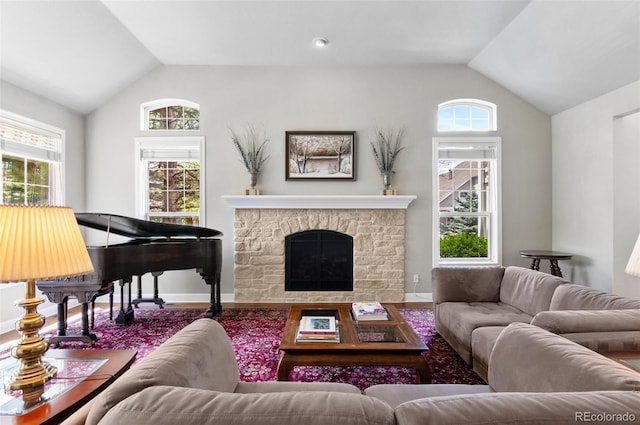 2032 W Nantucket Ct, Littleton, CO 80120 - living area with lofted ceiling, plenty of natural light, wood finished floors, baseboards, and a fireplace