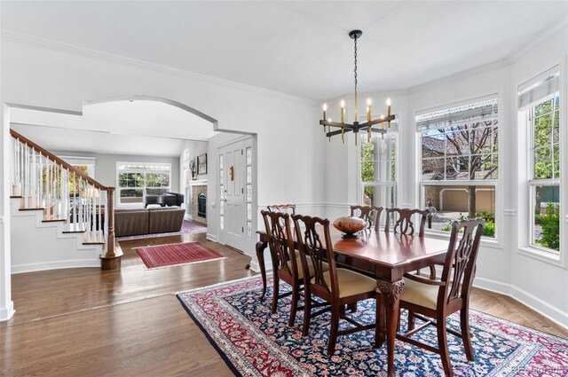 2032 W Nantucket Ct, Littleton, CO 80120 - dining area featuring a fireplace, plenty of natural light, crown molding, and baseboards