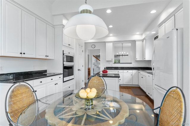 2032 W Nantucket Ct, Littleton, CO 80120 - kitchen featuring white appliances, white cabinets, dark countertops, a chandelier, and recessed lighting