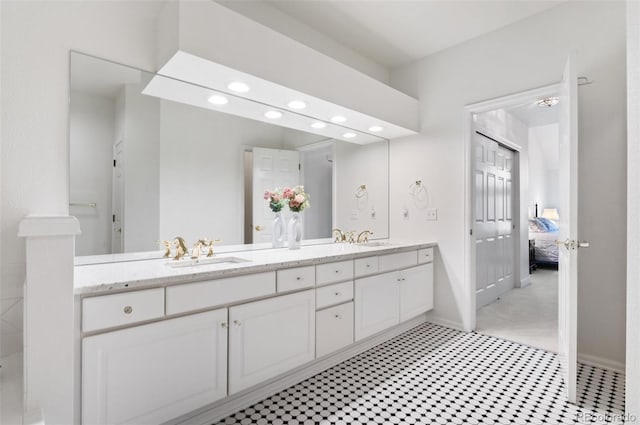 2032 W Nantucket Ct, Littleton, CO 80120 - bathroom featuring double vanity, recessed lighting, ensuite bath, tile patterned floors, and baseboards