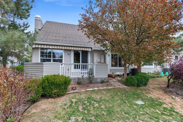 2032 W Nantucket Ct, Littleton, CO 80120 - view of front of home with a chimney, central air condition unit, and a front yard