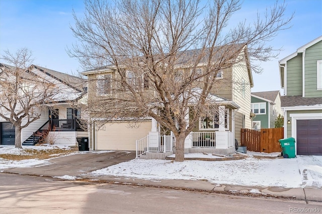 view of front of home featuring driveway and fence