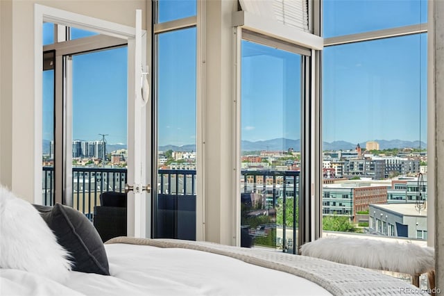 1700 Bassett St Unit 1014, Denver, CO 80202 - bedroom with a city view, access to exterior, french doors, a mountain view, and multiple windows