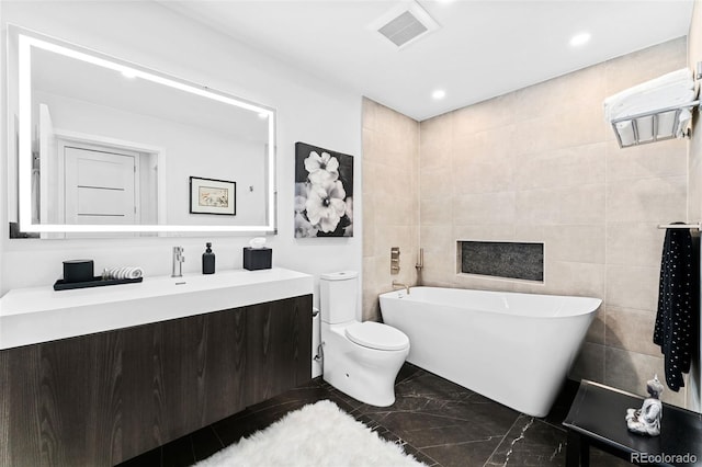 1700 Bassett St Unit 1014, Denver, CO 80202 - full bath with a freestanding tub, vanity, tile walls, marble finish floors, and recessed lighting