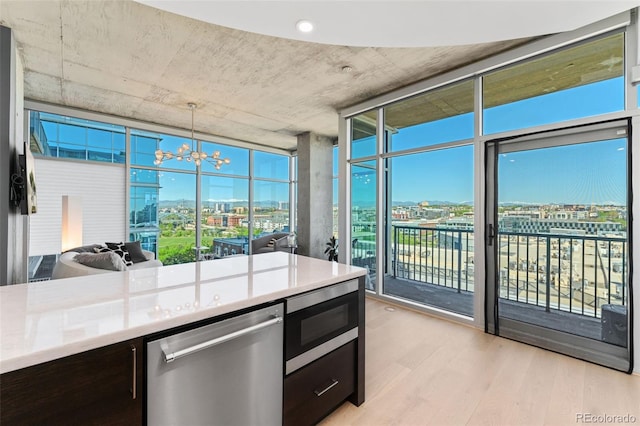 1700 Bassett St Unit 1014, Denver, CO 80202 - kitchen featuring stainless steel appliances, a wall of windows, a city view, light wood-style flooring, and a chandelier
