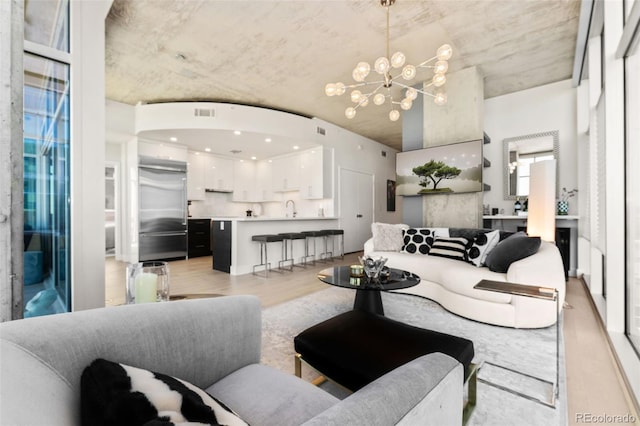 1700 Bassett St Unit 1014, Denver, CO 80202 - living room featuring light wood-type flooring and a chandelier