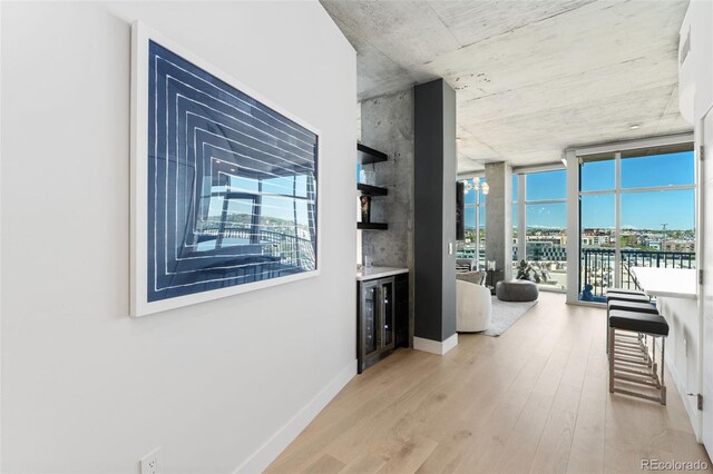 1700 Bassett St Unit 1014, Denver, CO 80202 - corridor featuring wood finished floors, wine cooler, and floor to ceiling windows