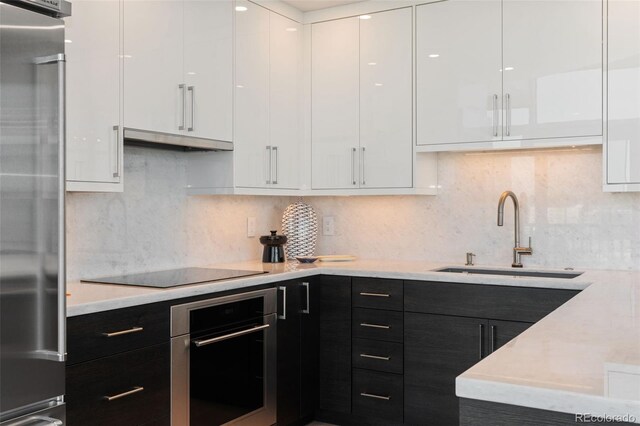1700 Bassett St Unit 1014, Denver, CO 80202 - kitchen with appliances with stainless steel finishes, modern cabinets, white cabinetry, and dark cabinets