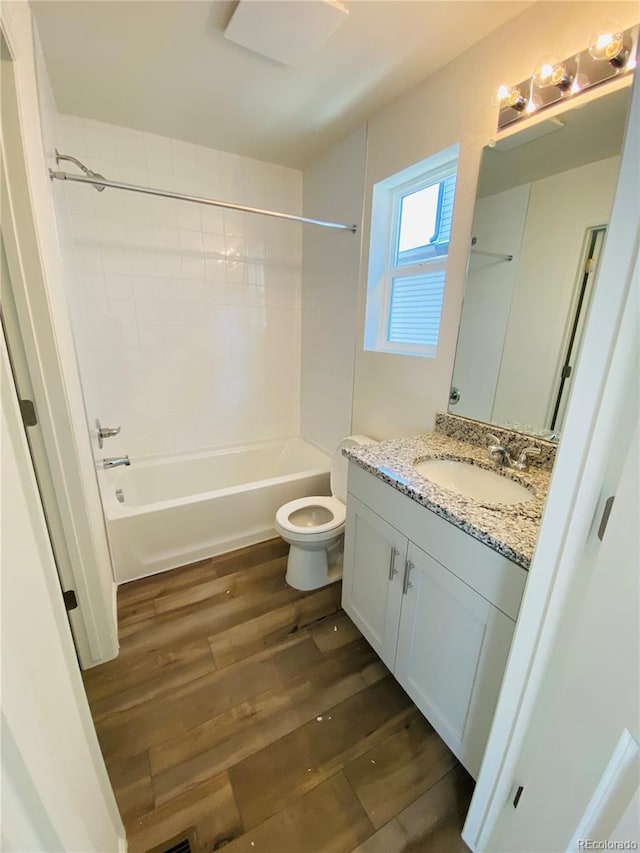 45016 Sunflower Ln, Bennett, CO 80102 - full bath with vanity, tub / shower combination, wood finished floors, and toilet