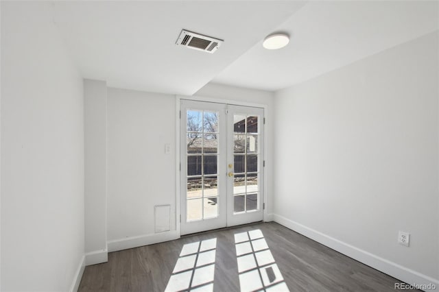 interior space with visible vents, french doors, baseboards, and wood finished floors