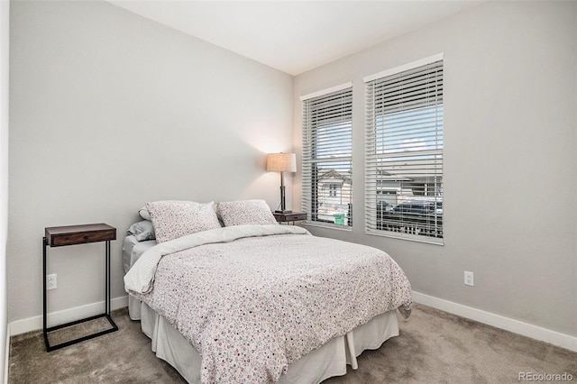 carpeted bedroom featuring baseboards
