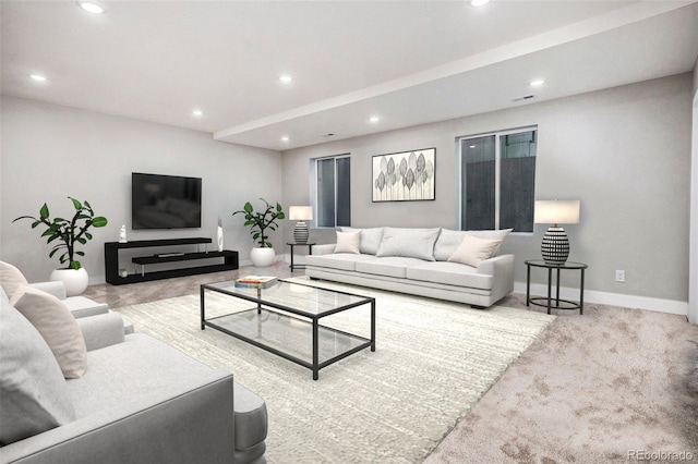 carpeted living room featuring baseboards and recessed lighting