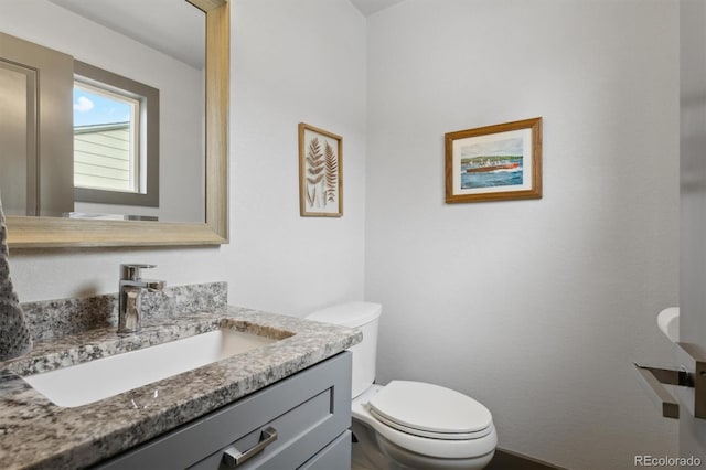 bathroom featuring vanity and toilet