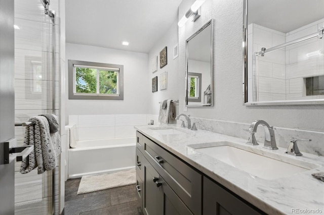 bathroom featuring vanity and separate shower and tub