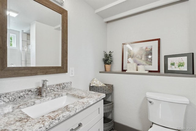 bathroom featuring vanity and toilet