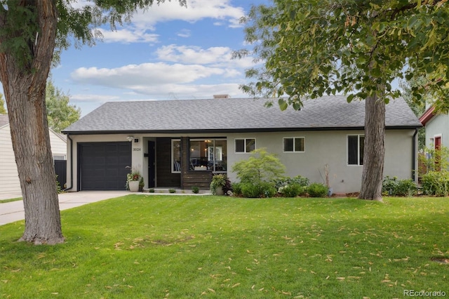 ranch-style house featuring a garage and a front lawn