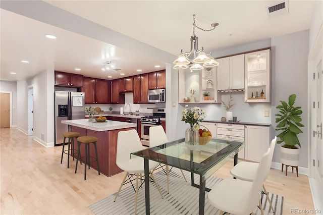 1630 N Clarkson St Unit 204, Denver, CO 80218 - dining room featuring light wood finished floors, recessed lighting, and a chandelier