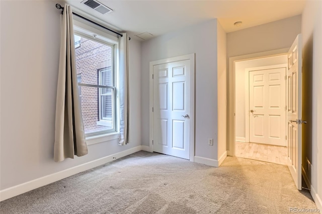 1630 N Clarkson St Unit 204, Denver, CO 80218 - unfurnished bedroom with carpet flooring and multiple windows