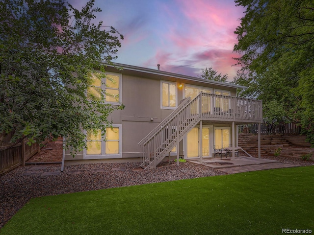 6378 S Emporia Cir, Englewood, CO 80111 - back of house at dusk with stairway, a wooden deck, and a patio