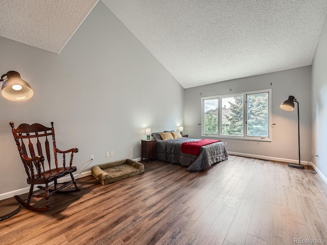 19098 E Ida Dr, Aurora, CO 80015 - bedroom with a textured ceiling, vaulted ceiling, wood finished floors, and baseboards
