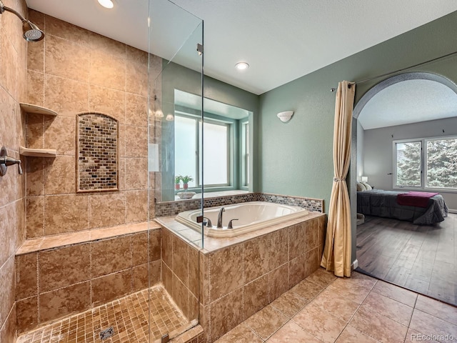 19098 E Ida Dr, Aurora, CO 80015 - bathroom featuring a tile shower, ensuite bathroom, a bath, recessed lighting, and tile patterned flooring