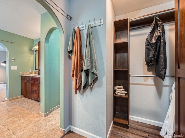 19098 E Ida Dr, Aurora, CO 80015 - spacious closet featuring arched walkways and light tile patterned floors