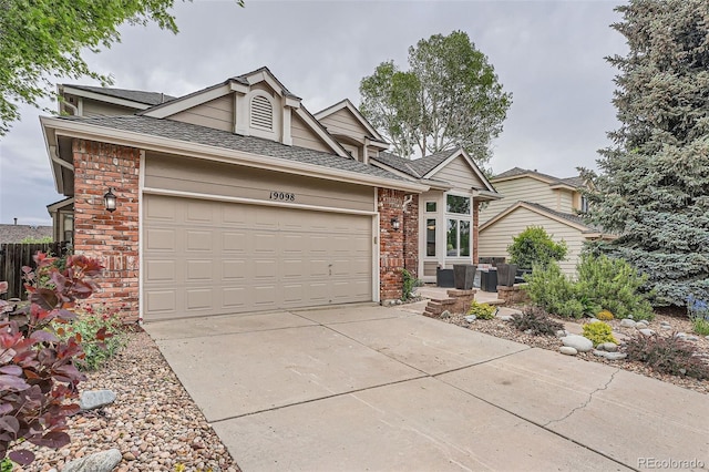 19098 E Ida Dr, Aurora, CO 80015 - view of front of property featuring brick siding, an attached garage, driveway, and a shingled roof