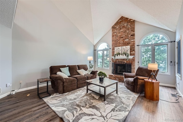 19098 E Ida Dr, Aurora, CO 80015 - living area with wood finished floors, high vaulted ceiling, baseboards, a brick fireplace, and a textured ceiling