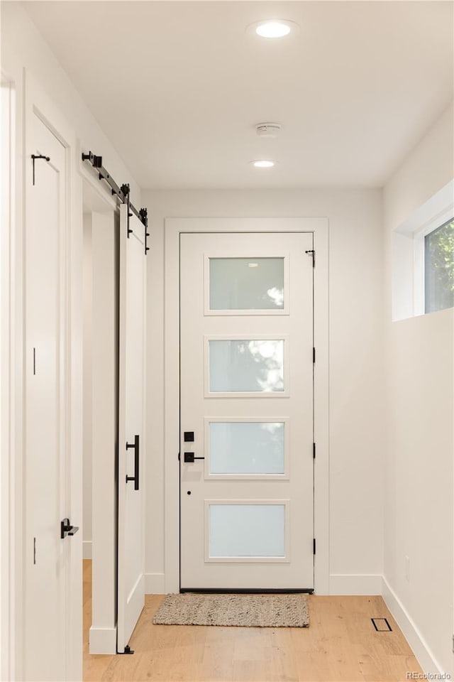 2060 Eliot St, Denver, CO 80211 - entryway featuring a barn door, light wood finished floors, and recessed lighting