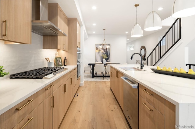 2060 Eliot St, Denver, CO 80211 - kitchen featuring wall chimney range hood, stainless steel appliances, light brown cabinets, backsplash, and light stone countertops
