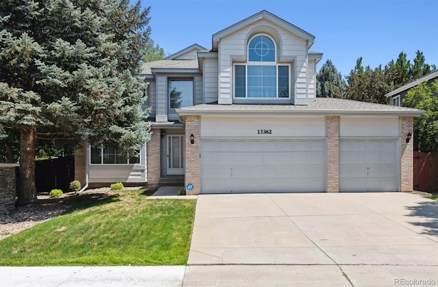 13362 Marion St, Thornton, CO 80241 - traditional-style home with brick siding, driveway, and an attached garage