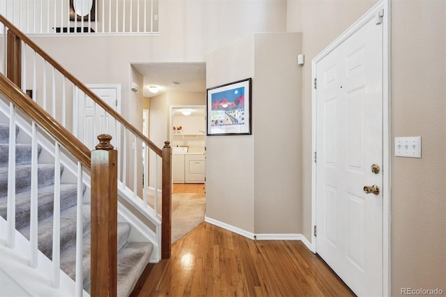 13362 Marion St, Thornton, CO 80241 - foyer featuring independent washer and dryer, wood finished floors, and stairway