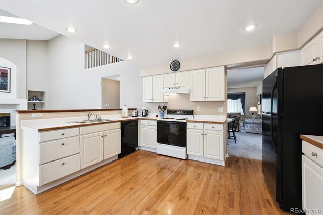 13362 Marion St, Thornton, CO 80241 - kitchen with black appliances, under cabinet range hood, light wood-style flooring, white cabinetry, and recessed lighting