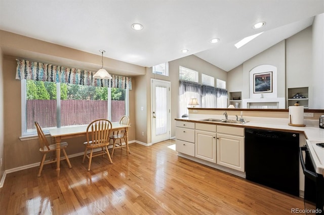 13362 Marion St, Thornton, CO 80241 - kitchen with dishwasher, a skylight, range with electric stovetop, light wood-style floors, and lofted ceiling