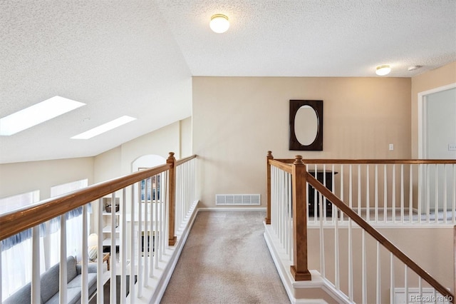 13362 Marion St, Thornton, CO 80241 - hall featuring a skylight, an upstairs landing, a textured ceiling, and carpet floors