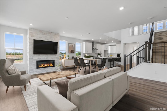 8863 Springsong Ln, Littleton, CO 80125 - living room with a fireplace, wood finished floors, stairs, and recessed lighting