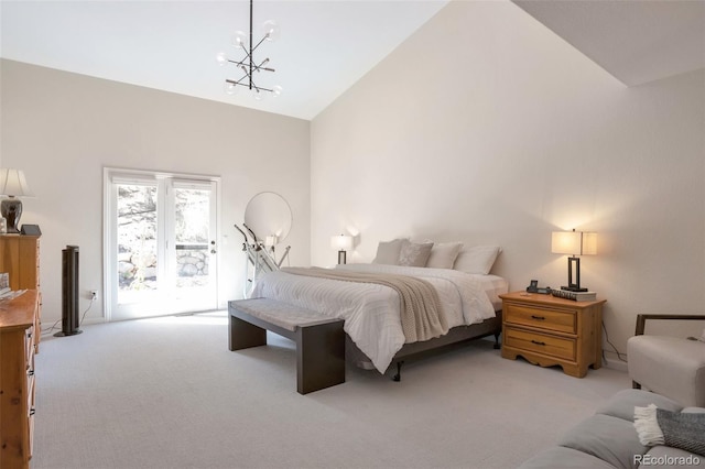 carpeted bedroom featuring an inviting chandelier, access to exterior, and high vaulted ceiling