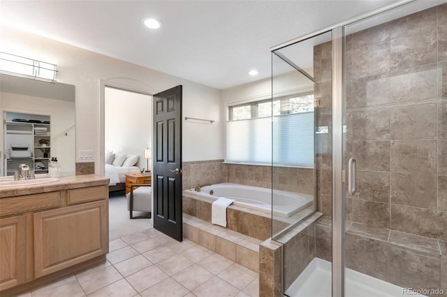 bathroom featuring tile patterned floors, vanity, and independent shower and bath