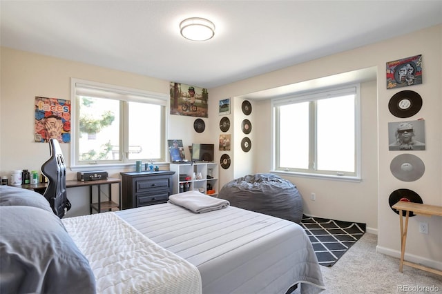 bedroom with carpet flooring and multiple windows