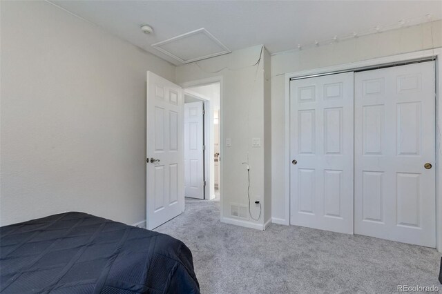 unfurnished bedroom featuring a closet and light carpet