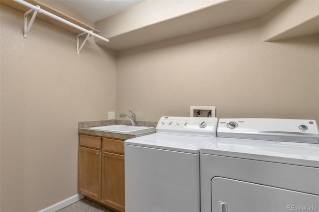 laundry room with cabinets, sink, and washing machine and clothes dryer