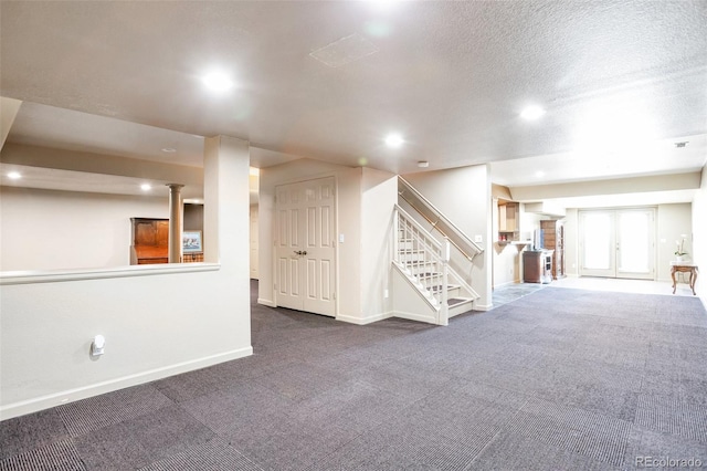 basement featuring carpet flooring and a textured ceiling