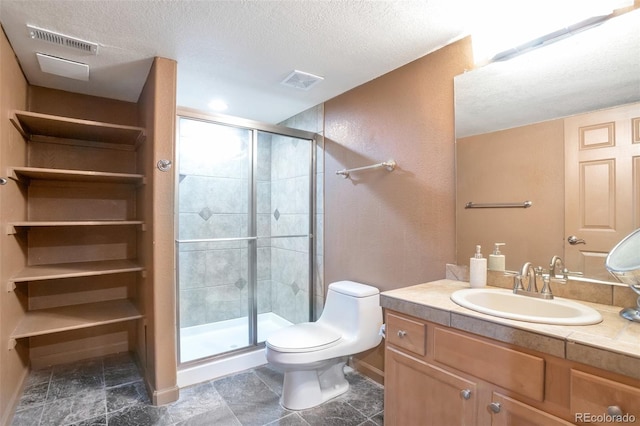 bathroom featuring walk in shower, vanity, toilet, and a textured ceiling