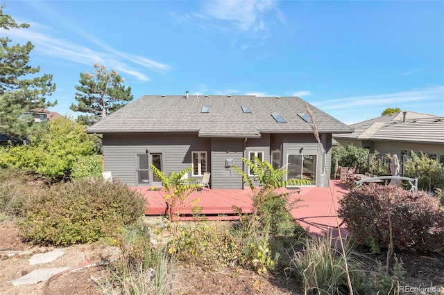 rear view of property with a wooden deck