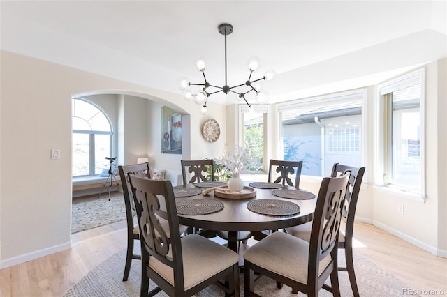 dining room with a notable chandelier and light hardwood / wood-style flooring