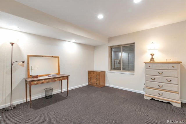 miscellaneous room featuring dark colored carpet