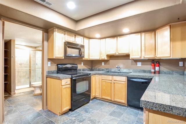 kitchen featuring light brown cabinetry, sink, and black appliances