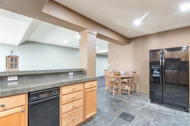 kitchen featuring light brown cabinetry and black fridge with ice dispenser